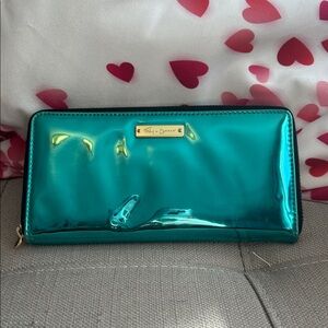 Foley & Corinna leather zip-around wallet in a metallic turquoise color